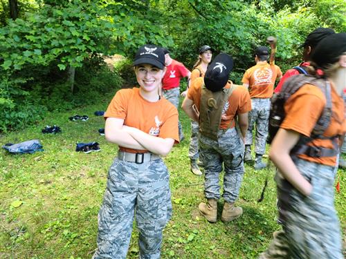 Cadet with folded arms smiles big