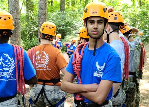 Cadet poses while wearing his high ropes safety gear