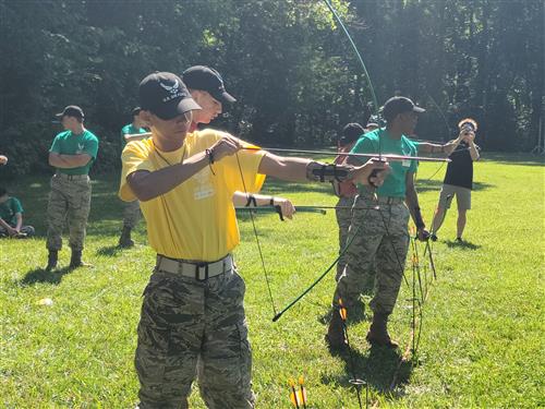Cadet aiming bow and arrow before shooting
