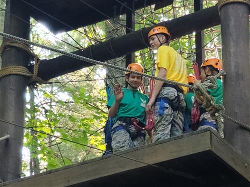 Cadet waves while on a high ropes course platform